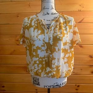 Beautiful yellow and white floral top with decorative tassels. Size M.